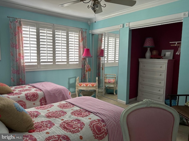 bedroom featuring ceiling fan, crown molding, and carpet flooring