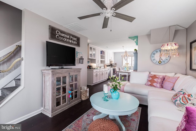 living room featuring sink, ceiling fan with notable chandelier, and dark hardwood / wood-style flooring