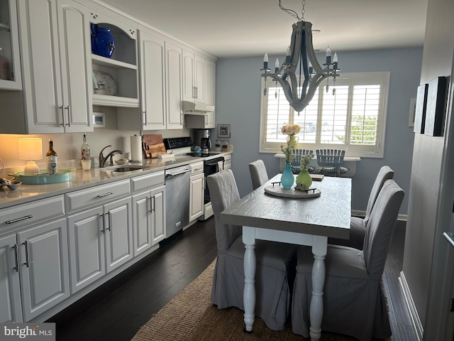 kitchen featuring white cabinetry, stainless steel dishwasher, dark wood-type flooring, stove, and a notable chandelier