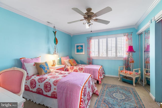 carpeted bedroom with ceiling fan and ornamental molding