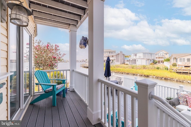 wooden deck featuring a water view