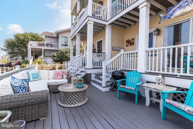 wooden deck with an outdoor living space