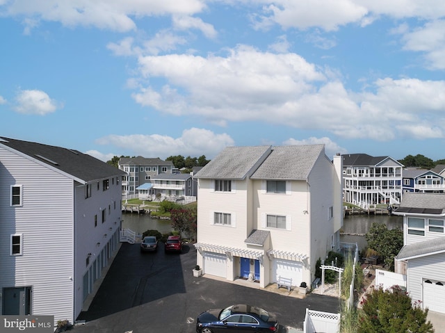 exterior space featuring a water view and a garage