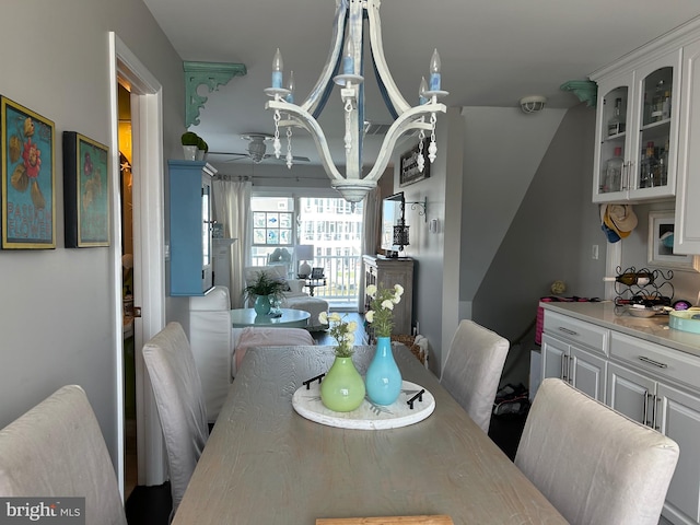 dining room featuring ceiling fan with notable chandelier