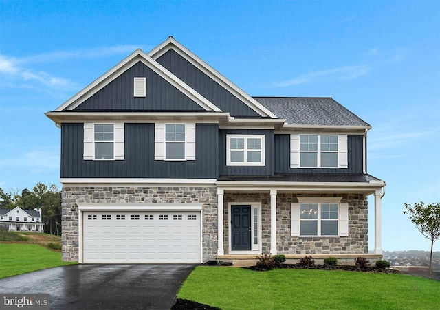 craftsman-style home featuring a garage and a front yard