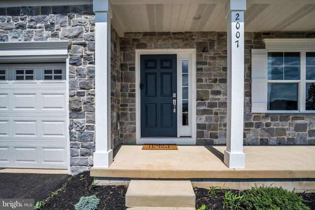 view of exterior entry featuring a garage