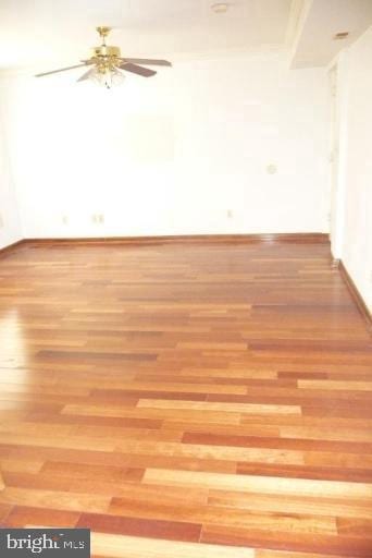 spare room featuring light hardwood / wood-style flooring and ceiling fan