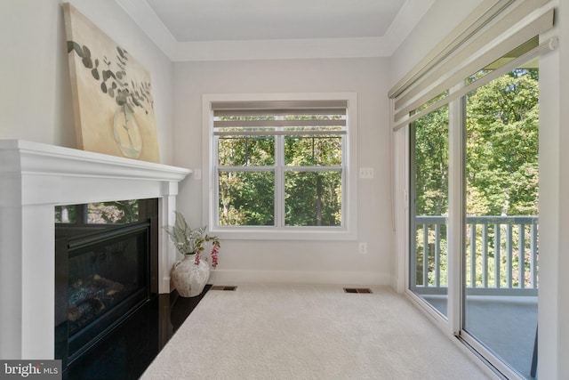 living room with a high end fireplace, carpet flooring, and ornamental molding