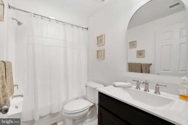 full bathroom featuring vanity, shower / tub combo, and toilet