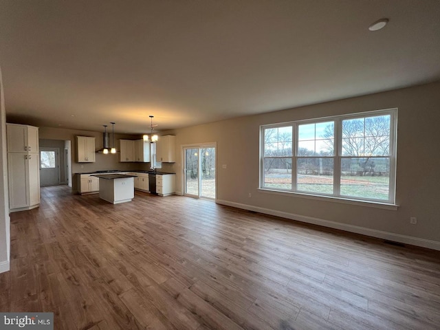 unfurnished living room featuring hardwood / wood-style flooring