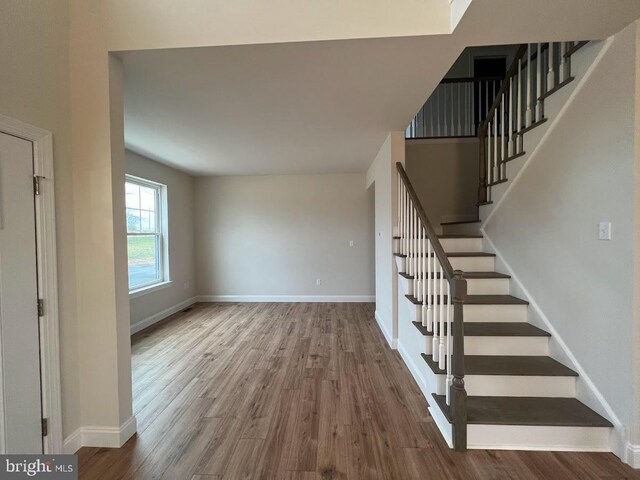 stairway featuring hardwood / wood-style flooring