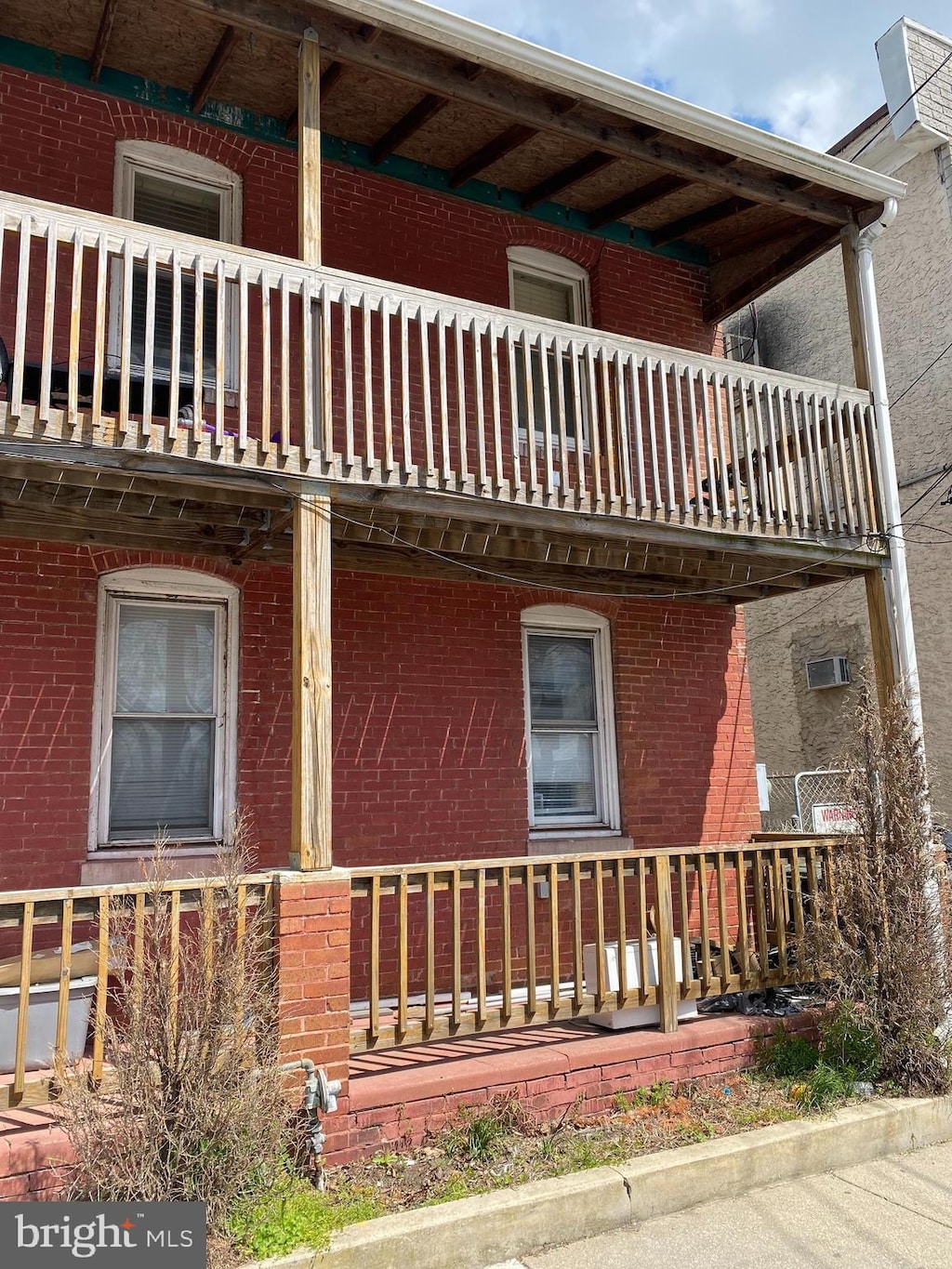 view of side of home featuring a balcony