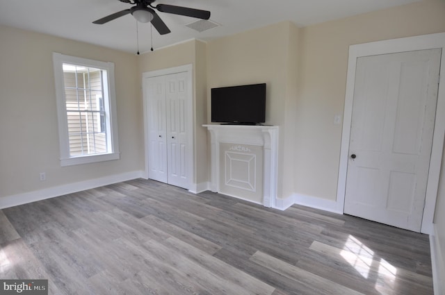 unfurnished living room featuring light hardwood / wood-style flooring and ceiling fan