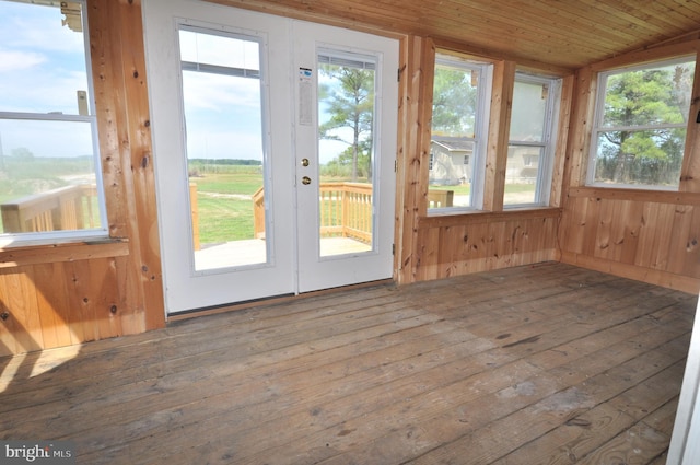 entryway with wood walls, wood-type flooring, vaulted ceiling, and wooden ceiling