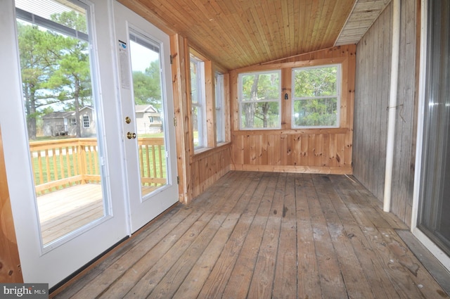 unfurnished sunroom with wood ceiling, a healthy amount of sunlight, and lofted ceiling