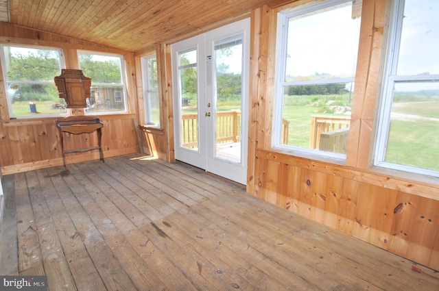 unfurnished sunroom featuring lofted ceiling and wooden ceiling