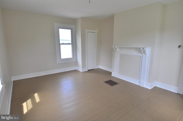 unfurnished living room featuring hardwood / wood-style floors