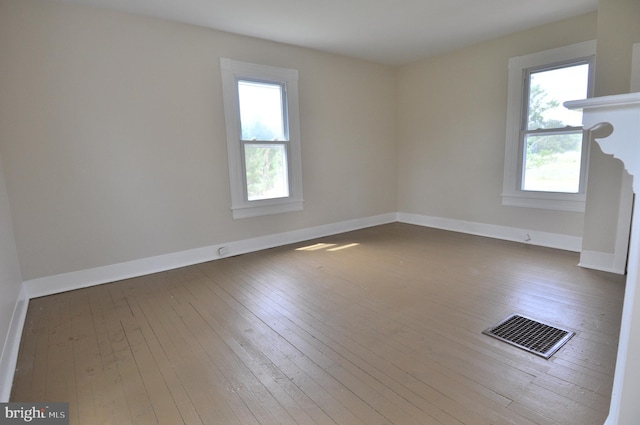 spare room with hardwood / wood-style floors