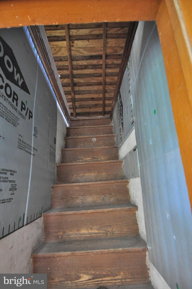 staircase with wood ceiling