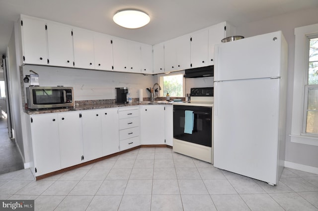 kitchen with white refrigerator, white cabinetry, sink, and range with electric stovetop