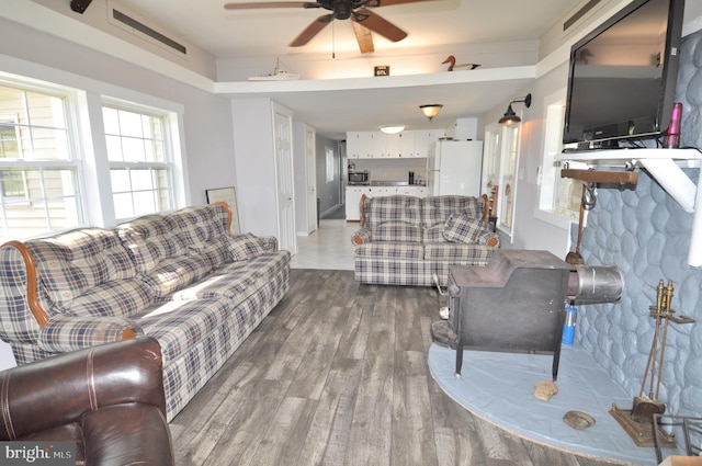 living room featuring wood-type flooring and ceiling fan