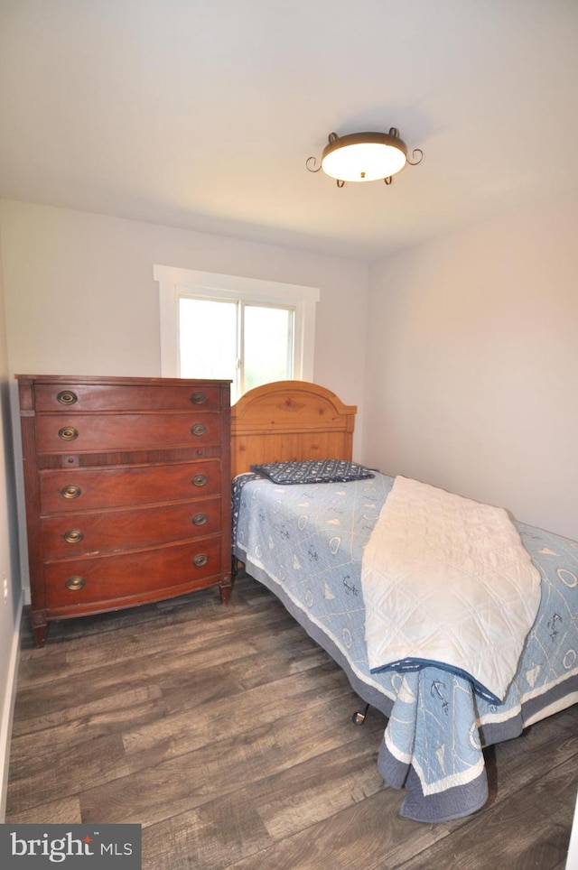 bedroom with dark hardwood / wood-style floors