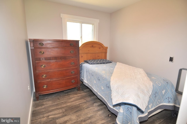 bedroom with dark wood-type flooring