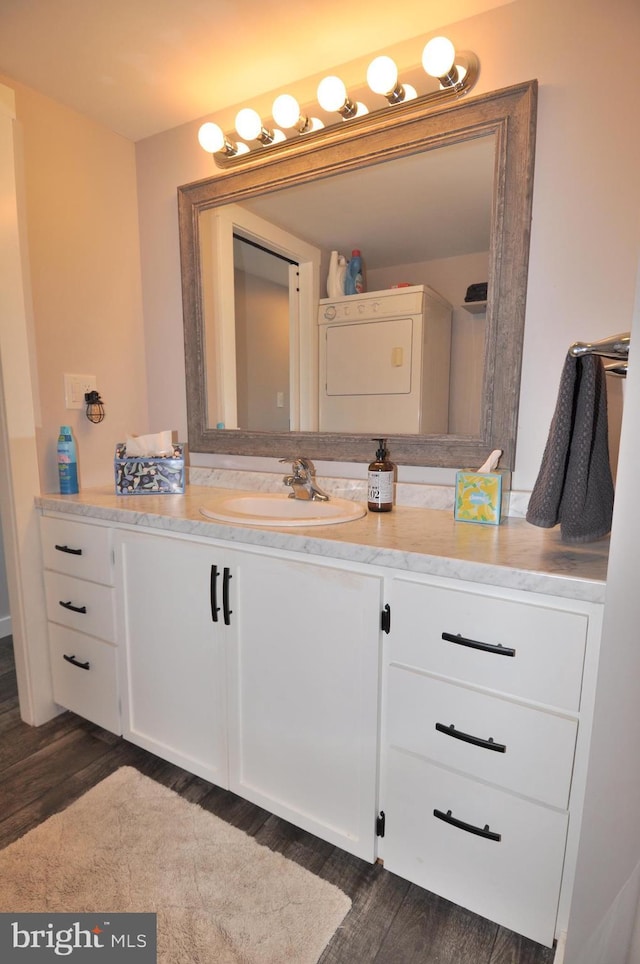 bathroom with vanity, washer / clothes dryer, and hardwood / wood-style floors