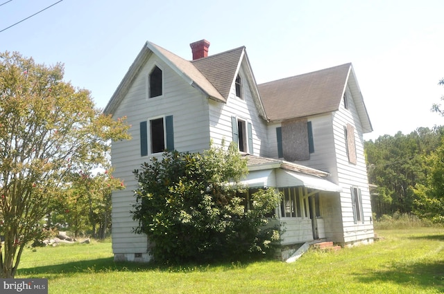 view of property exterior featuring a lawn