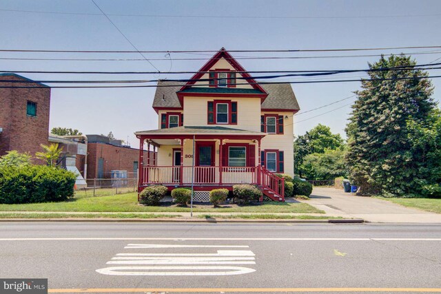 victorian-style house featuring covered porch