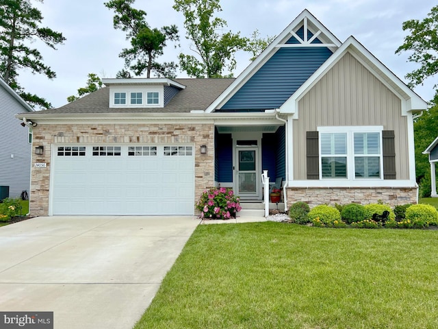 craftsman house with central AC unit, a garage, and a front lawn