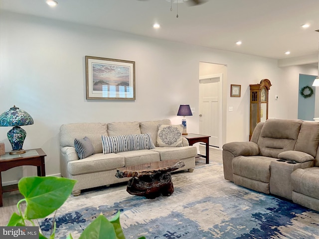 living room featuring wood-type flooring and ceiling fan