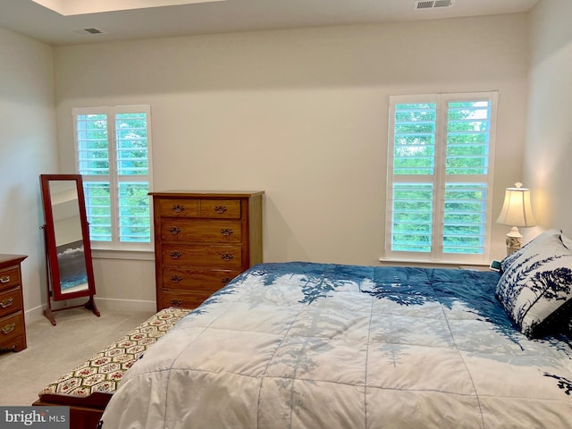 bedroom featuring light colored carpet