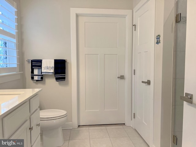 bathroom featuring tile patterned floors, toilet, and vanity