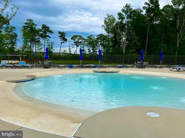 view of swimming pool featuring a patio area and pool water feature