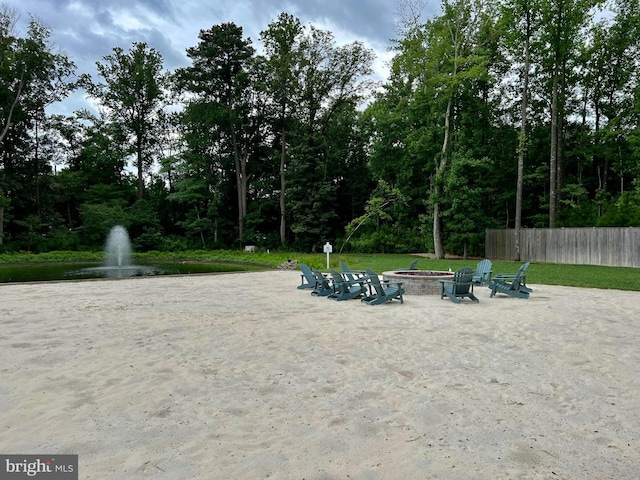 view of property's community featuring a patio and an outdoor fire pit