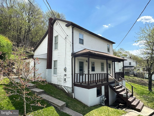 view of front facade with central air condition unit, a front lawn, and covered porch