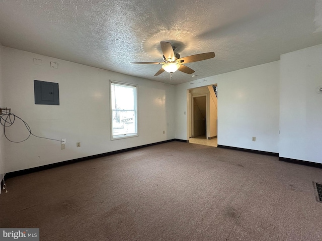 carpeted empty room with ceiling fan, a textured ceiling, and electric panel