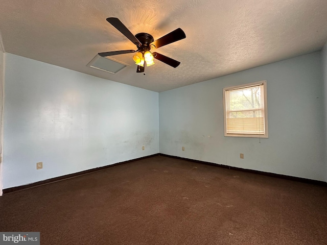 carpeted empty room with a textured ceiling