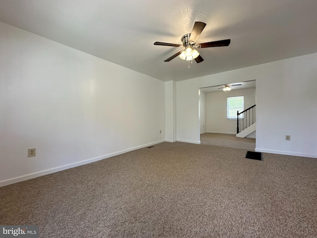 empty room with ceiling fan and carpet