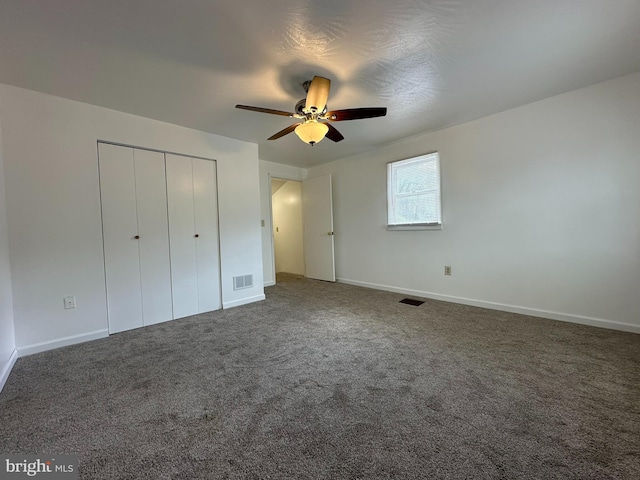 unfurnished bedroom featuring ceiling fan, a closet, and carpet floors