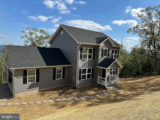 view of front of house with a shingled roof