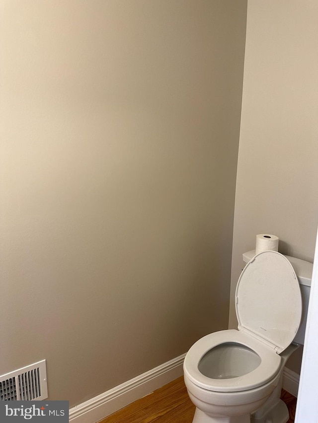 bathroom featuring toilet and hardwood / wood-style flooring