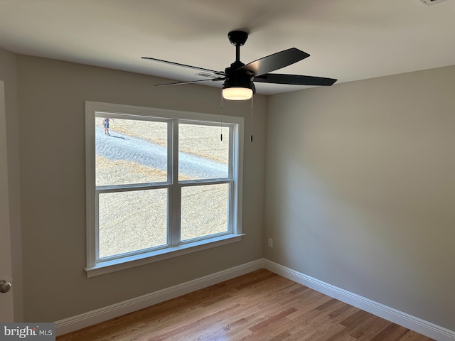 unfurnished room with ceiling fan and light wood-type flooring