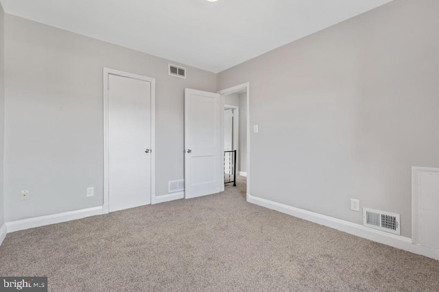 unfurnished bedroom with light colored carpet