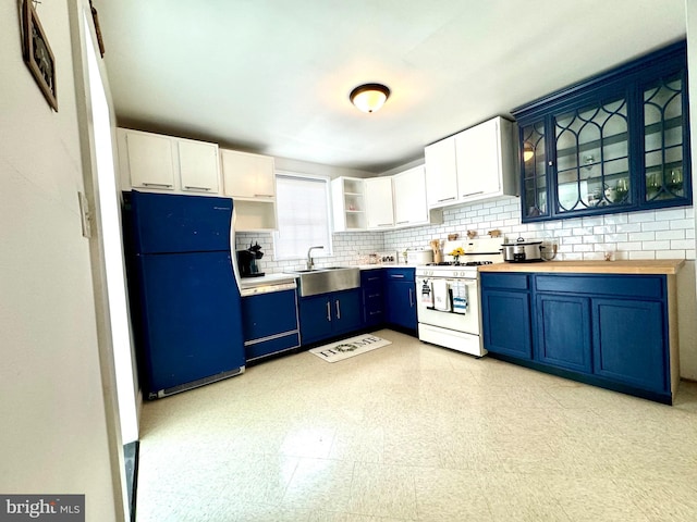 kitchen featuring sink, fridge, white gas range, dishwasher, and white cabinets