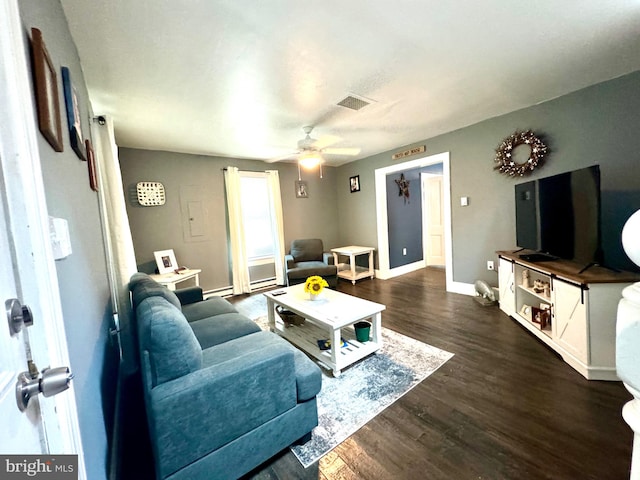 living room with ceiling fan and dark hardwood / wood-style flooring