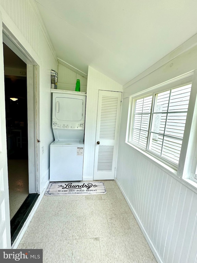 laundry area with stacked washer and clothes dryer