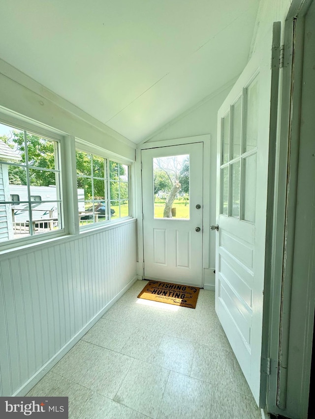 unfurnished sunroom featuring vaulted ceiling