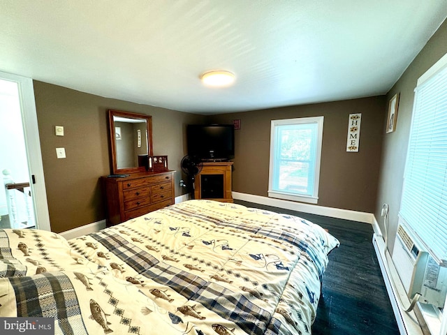 bedroom featuring dark hardwood / wood-style flooring and baseboard heating